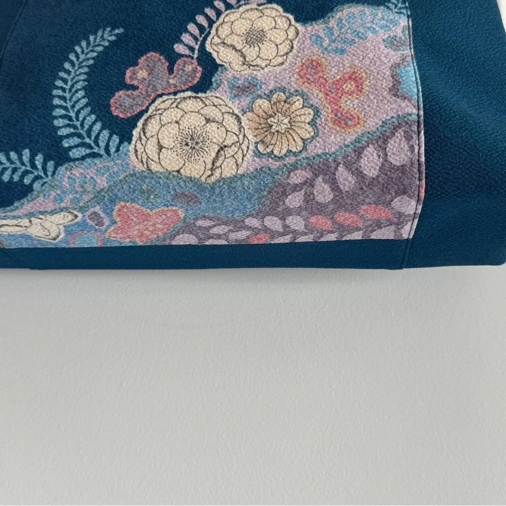 Teal-colored‎ handbag bag featuring intricate floral embroidery